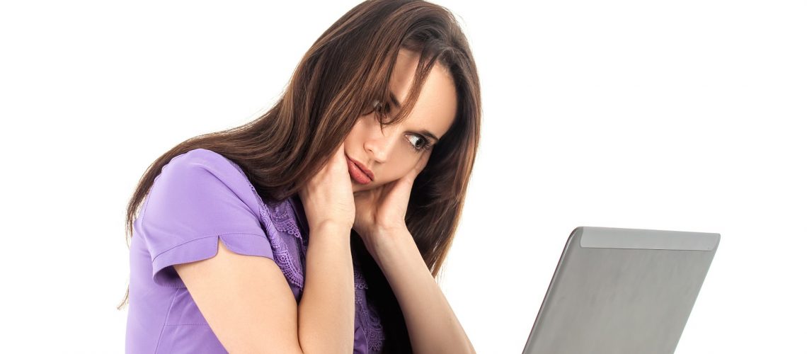 Fatigued woman sitting at a laptop